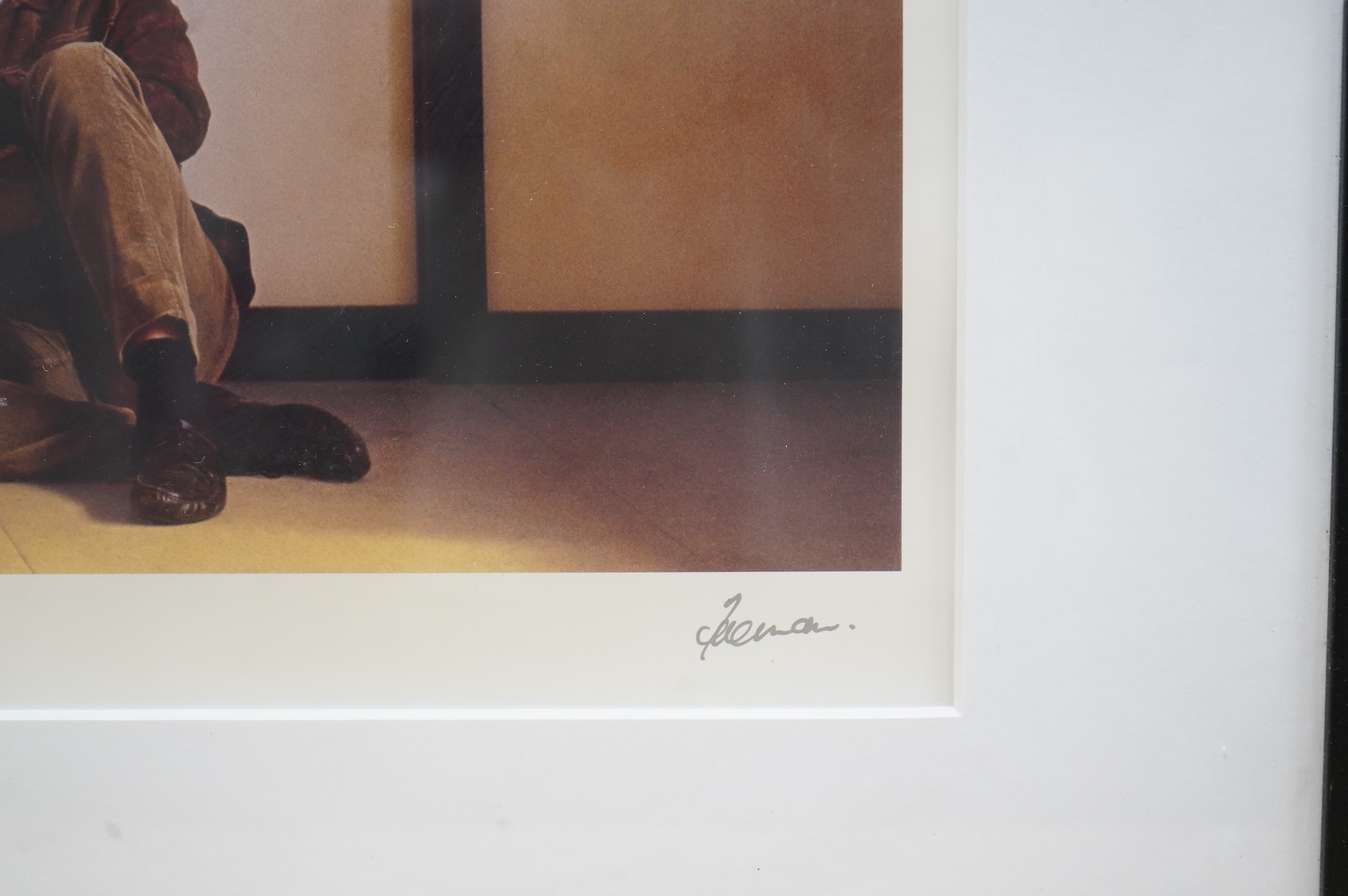 A framed and mounted photograph of John Lennon by Robert Freeman, posing with a toy panda, signed in the margin at the bottom right, 45 x 71cm